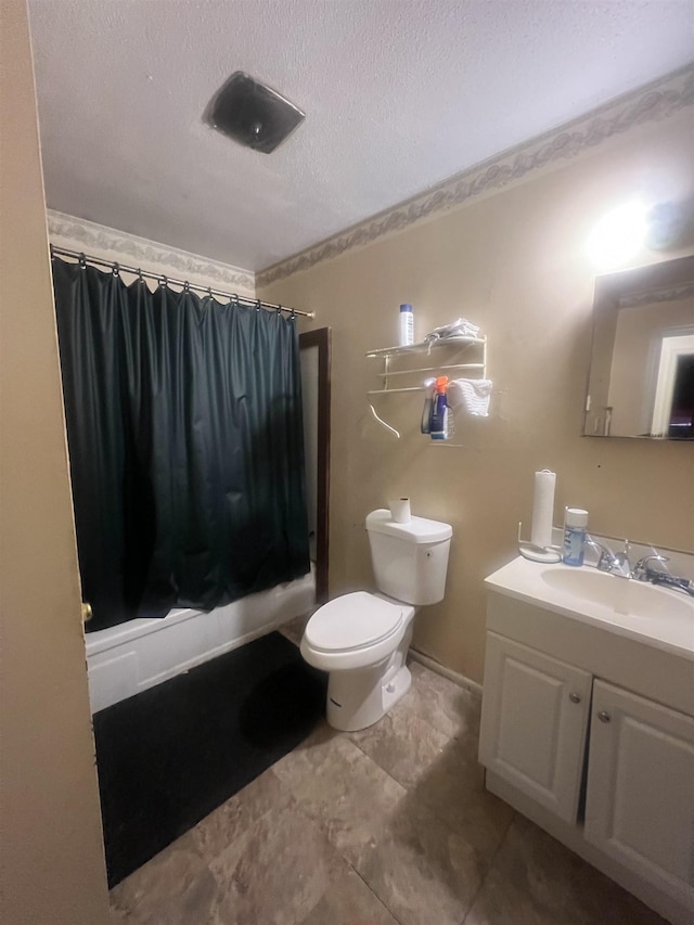 bathroom featuring a textured ceiling, vanity, and toilet