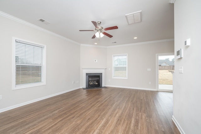 unfurnished living room with ceiling fan, ornamental molding, and wood-type flooring