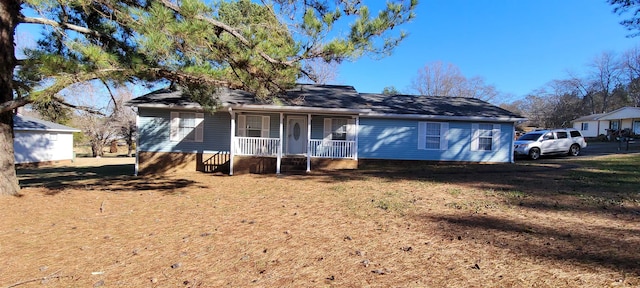 view of front of property with covered porch and a front yard