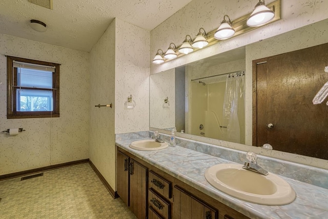 bathroom featuring vanity and a textured ceiling