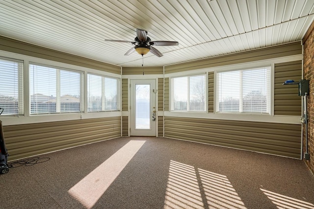 unfurnished sunroom with ceiling fan