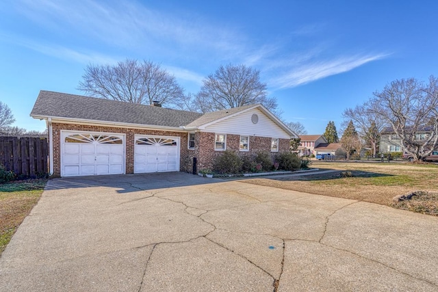 ranch-style house featuring a front yard and a garage