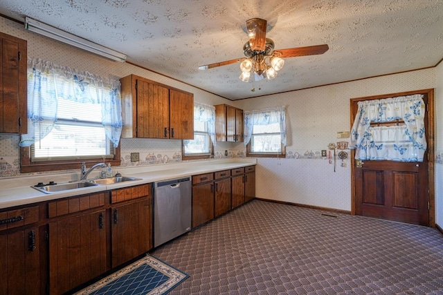 kitchen featuring ceiling fan, sink, stainless steel dishwasher, crown molding, and a textured ceiling