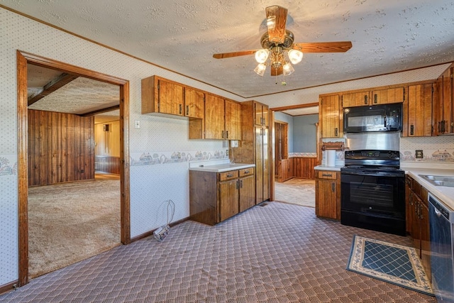 kitchen featuring carpet, ornamental molding, a textured ceiling, ceiling fan, and black appliances