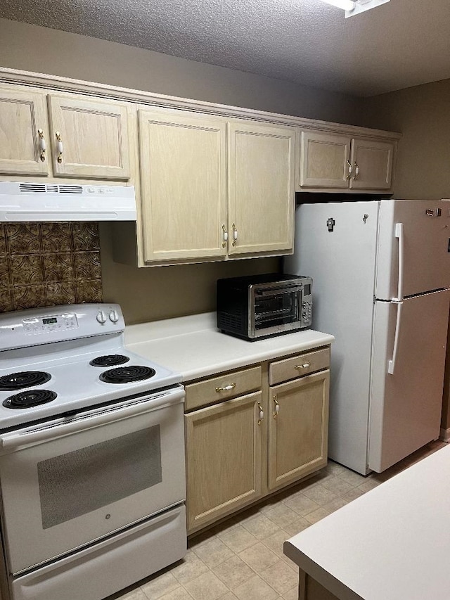 kitchen featuring a textured ceiling, white appliances, and tasteful backsplash