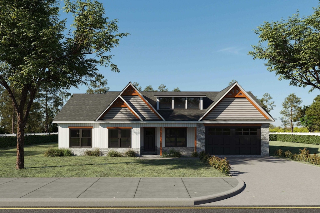 craftsman-style house with a garage and a front lawn