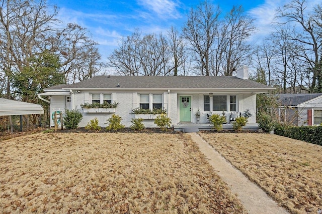 single story home featuring a front lawn, covered porch, and a carport