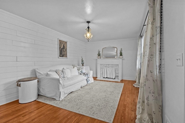 living room featuring crown molding and light hardwood / wood-style floors