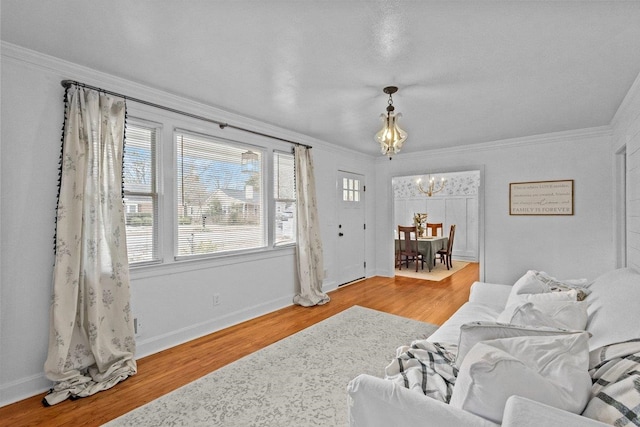 living room featuring crown molding, a chandelier, and hardwood / wood-style flooring