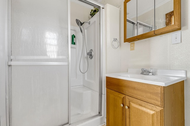 bathroom featuring vanity and an enclosed shower