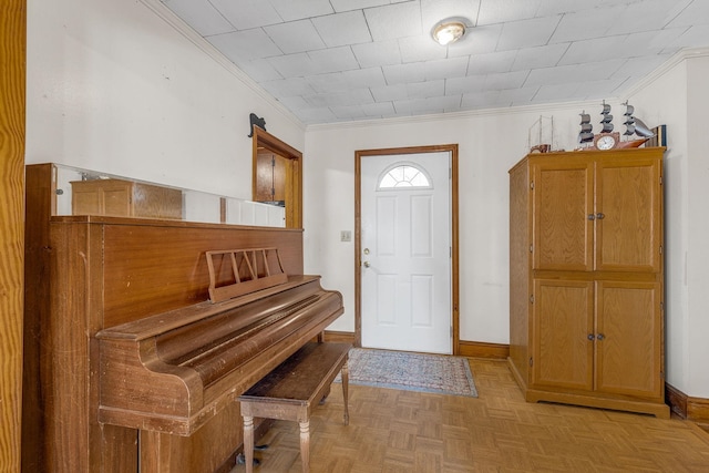 entryway with light parquet flooring and ornamental molding