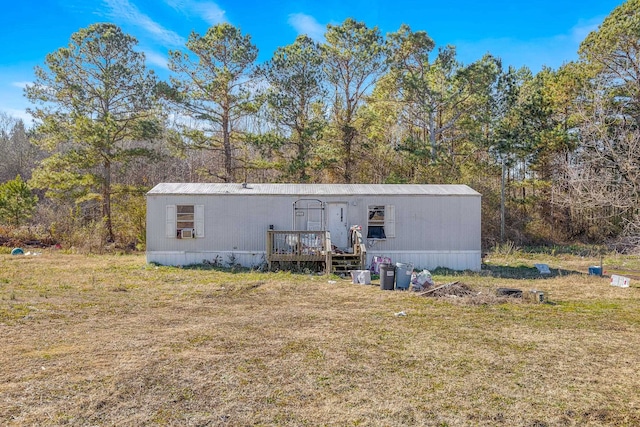 back of house with a wooden deck and a yard