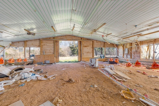 misc room featuring wooden walls and vaulted ceiling