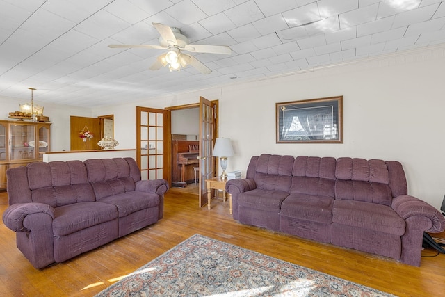 living room featuring ceiling fan, french doors, and light wood-type flooring