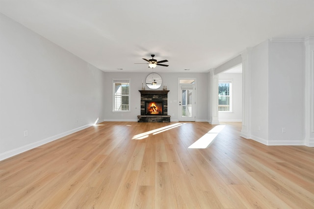 unfurnished living room with a fireplace, light hardwood / wood-style floors, and plenty of natural light