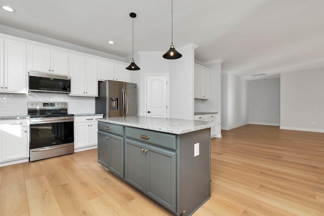 kitchen with a kitchen island, appliances with stainless steel finishes, gray cabinets, and white cabinetry