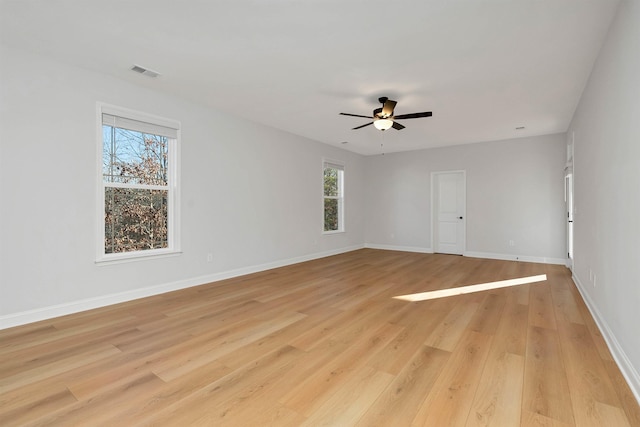 spare room with ceiling fan and light wood-type flooring