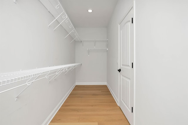 spacious closet with hardwood / wood-style floors