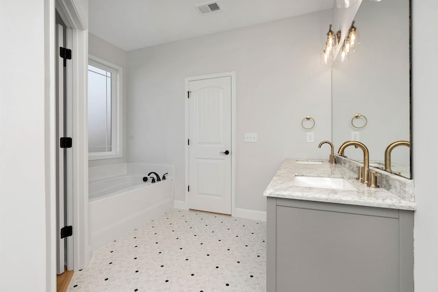 bathroom featuring a tub and vanity