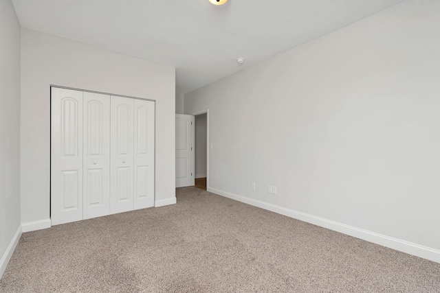 unfurnished bedroom with a closet and carpet flooring