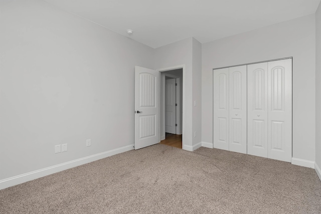 unfurnished bedroom with a closet and carpet