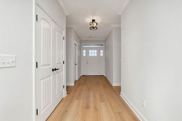 corridor with crown molding and light hardwood / wood-style flooring