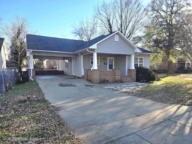 ranch-style home featuring a carport and a porch