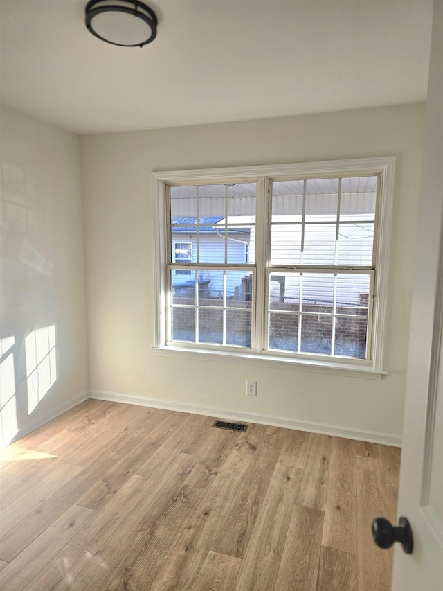 spare room with light hardwood / wood-style flooring