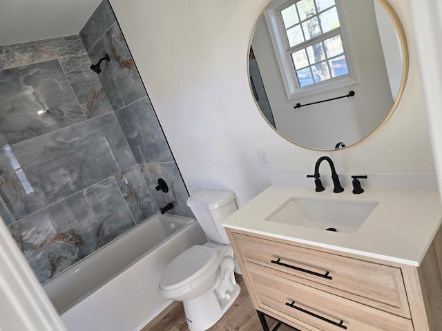 full bathroom featuring wood-type flooring, vanity, toilet, and tiled shower / bath