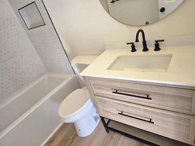 full bathroom with toilet, vanity, hardwood / wood-style floors, and tub / shower combination