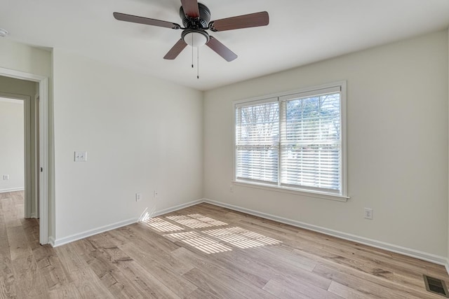 spare room featuring light wood-type flooring and ceiling fan