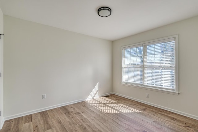 unfurnished room with light hardwood / wood-style flooring