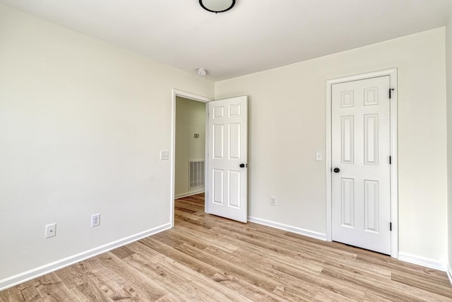 unfurnished bedroom with light wood-type flooring