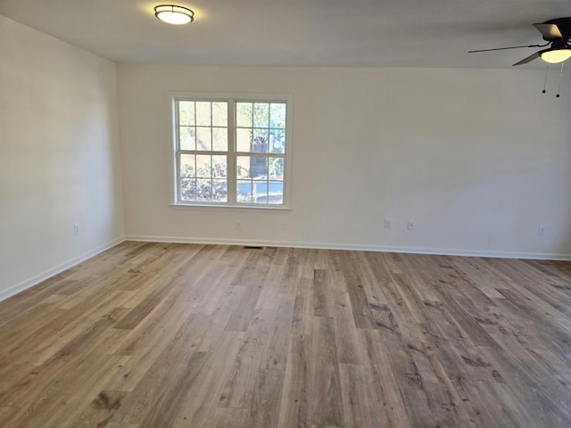 empty room with ceiling fan and light wood-type flooring