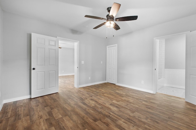 interior space with ceiling fan and dark hardwood / wood-style floors