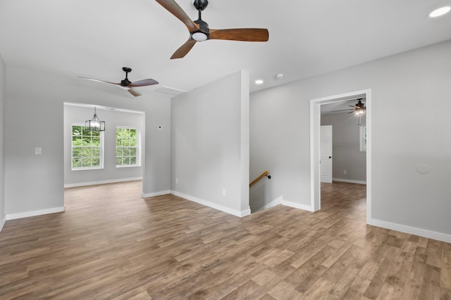 empty room featuring hardwood / wood-style floors and a notable chandelier