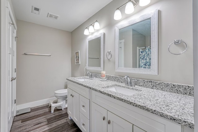 bathroom with curtained shower, hardwood / wood-style floors, vanity, and toilet