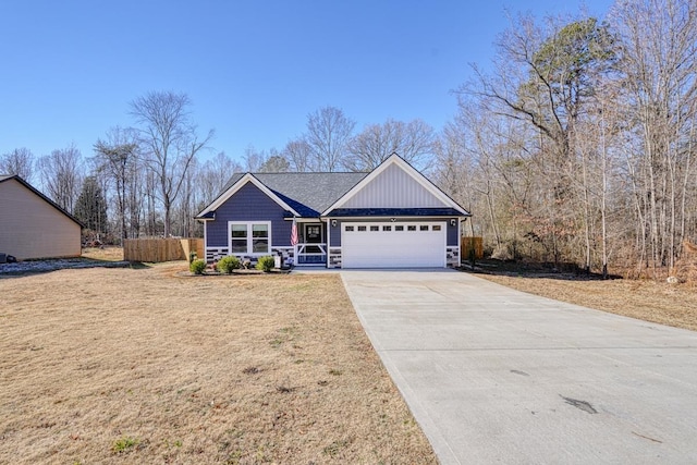 view of front of property with a front yard and a garage