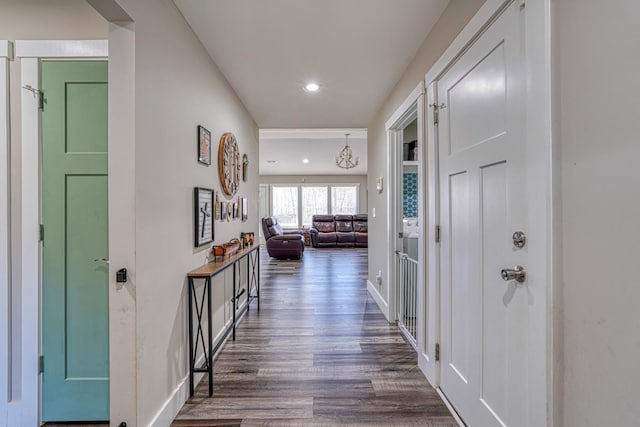 hall featuring a notable chandelier and dark hardwood / wood-style floors