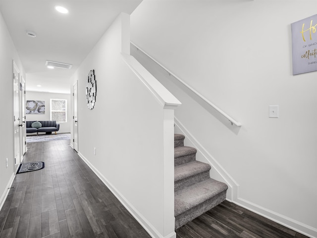 staircase with wood-type flooring