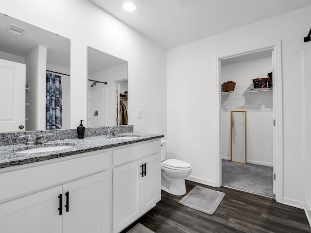 bathroom featuring toilet, vanity, a shower with shower curtain, and hardwood / wood-style floors