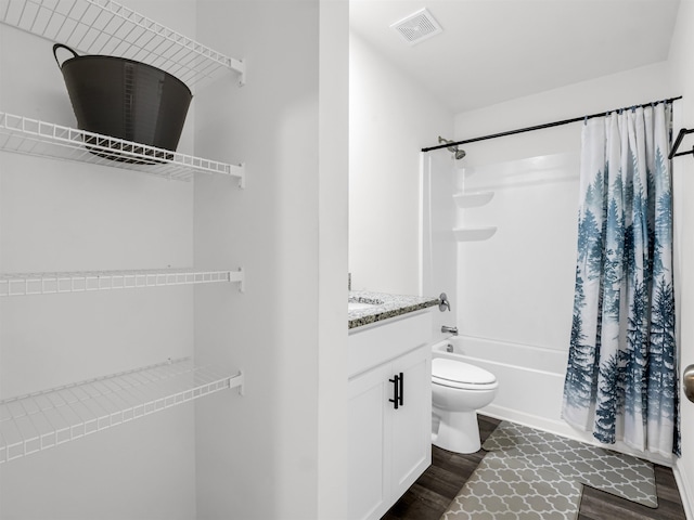 full bathroom with toilet, vanity, hardwood / wood-style floors, and shower / bathtub combination with curtain