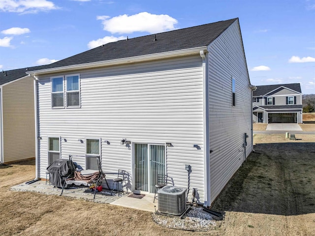 back of house featuring a patio area, central AC unit, and a yard