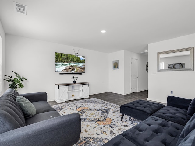 living room with dark hardwood / wood-style flooring