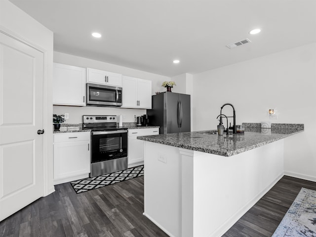 kitchen featuring kitchen peninsula, appliances with stainless steel finishes, white cabinetry, and sink