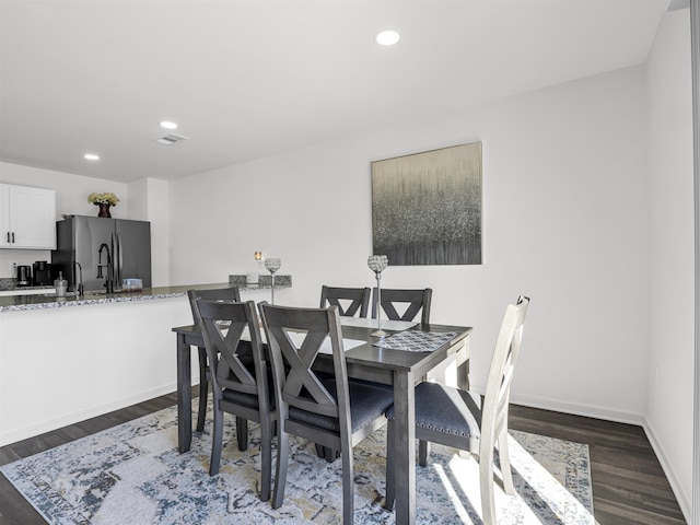 dining area featuring dark wood-type flooring