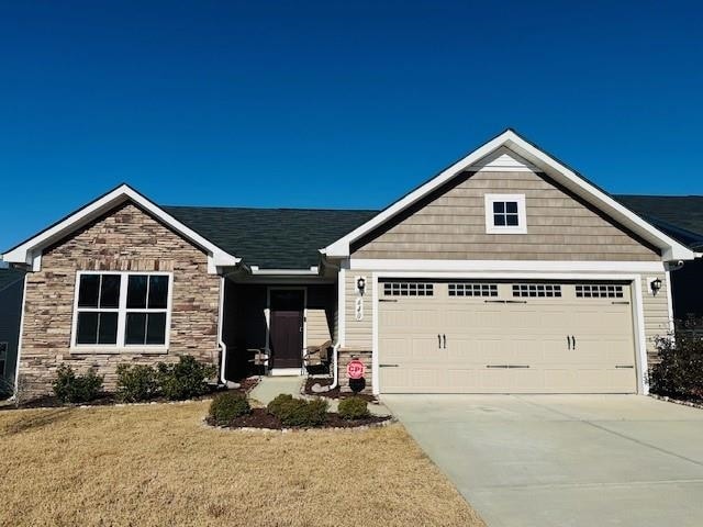 view of front of home featuring a front yard and a garage