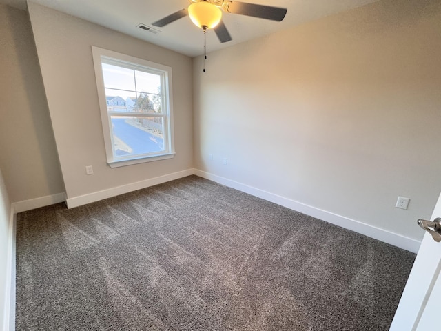 carpeted spare room featuring ceiling fan