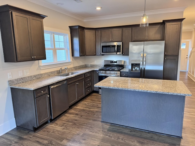 kitchen featuring a center island, decorative light fixtures, stainless steel appliances, dark hardwood / wood-style flooring, and sink