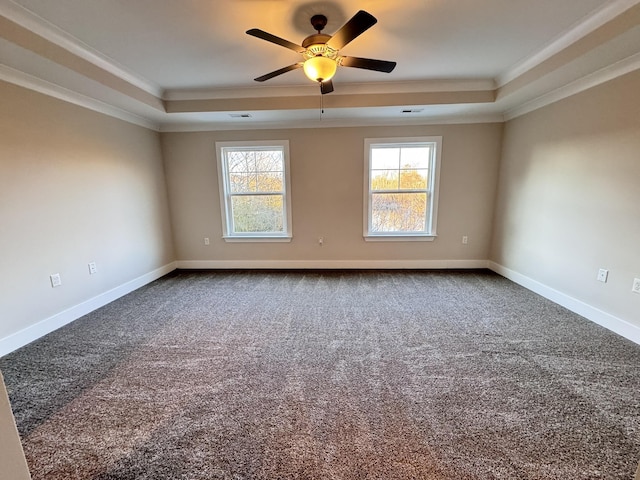 carpeted spare room with a raised ceiling, ceiling fan, and crown molding